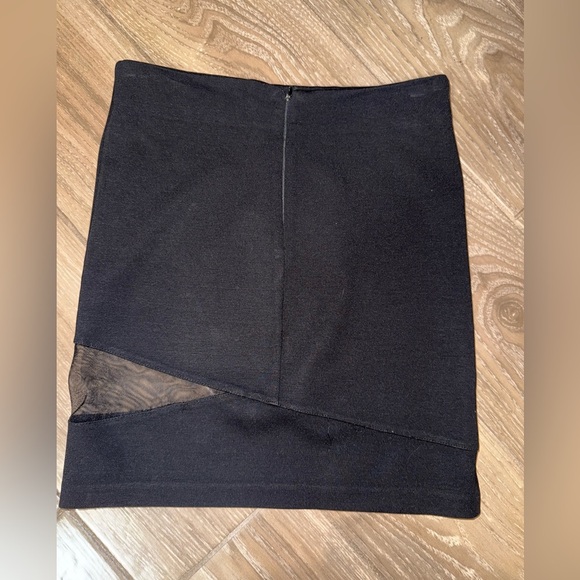 Black mini skirt BB Dakota featuring a unique diagonal sheer mesh panel detail.4 - Picture 4 of 8